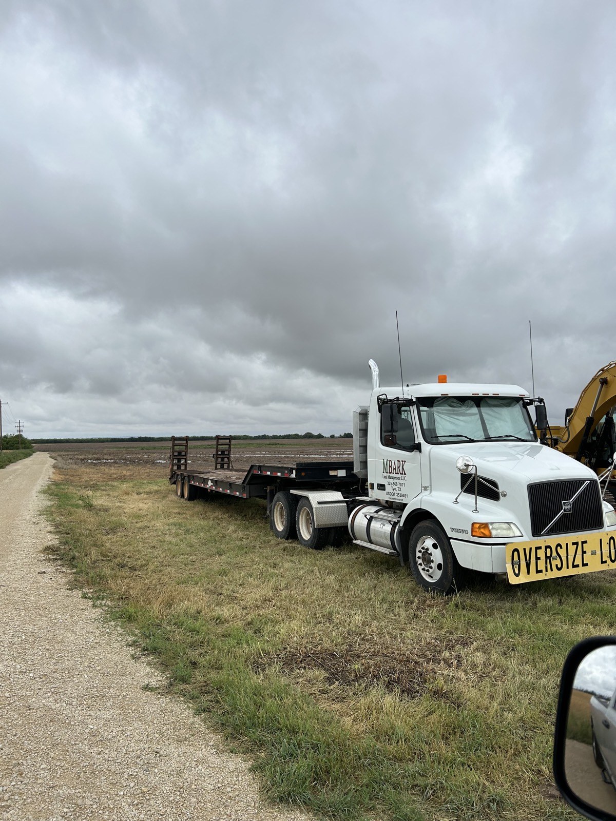 MBARK lowboy trailer hauling an excavator