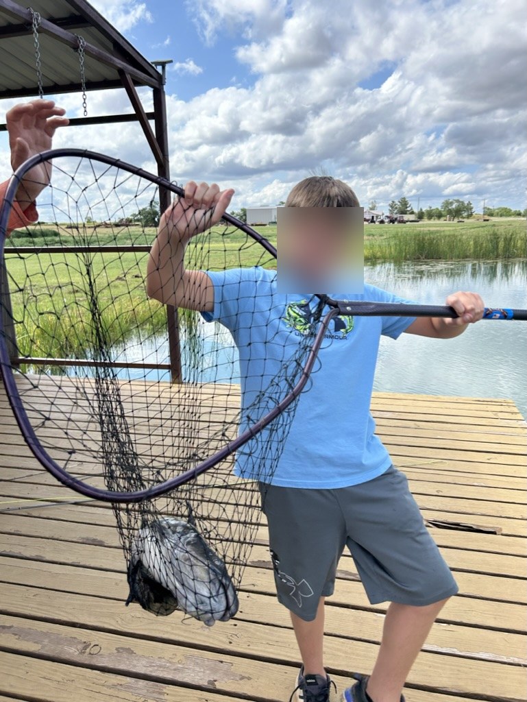 Child fishing from dock on MBARK-built pond — family fun on the water