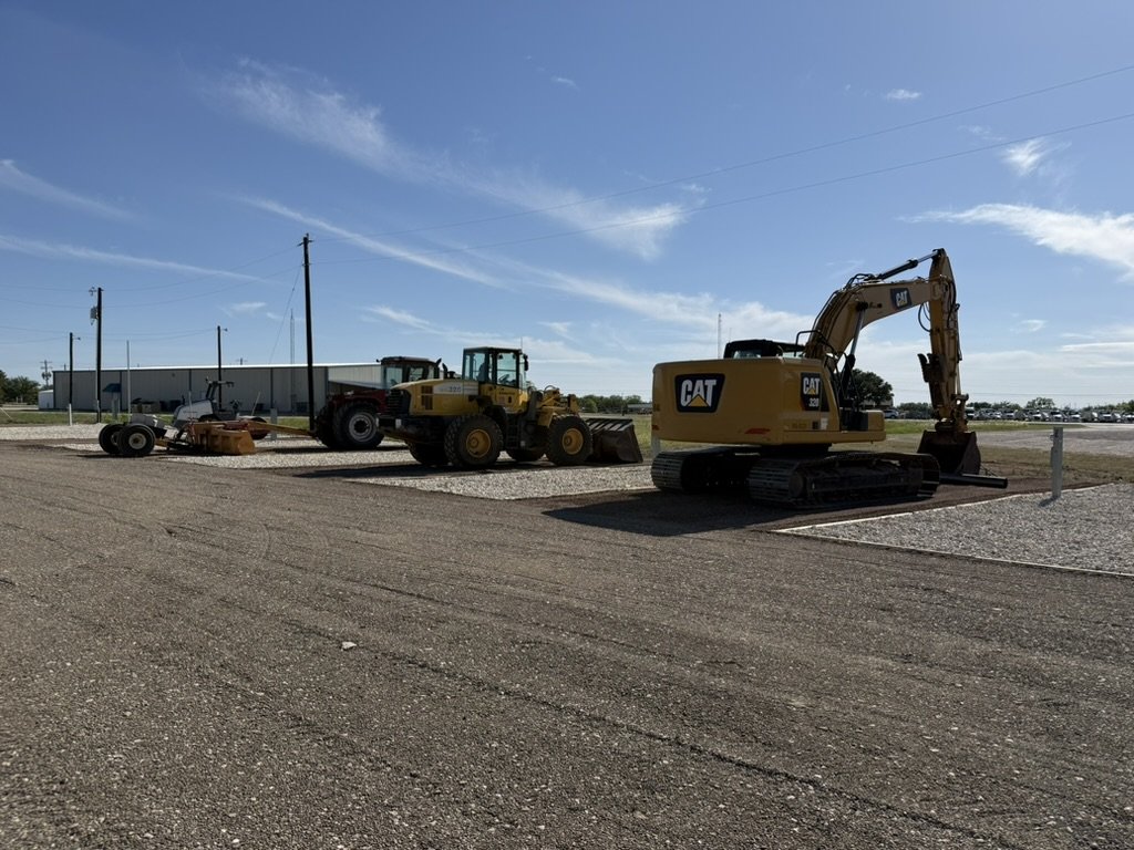 Commercial site prep — CAT excavator and wheel loader on finished pad
