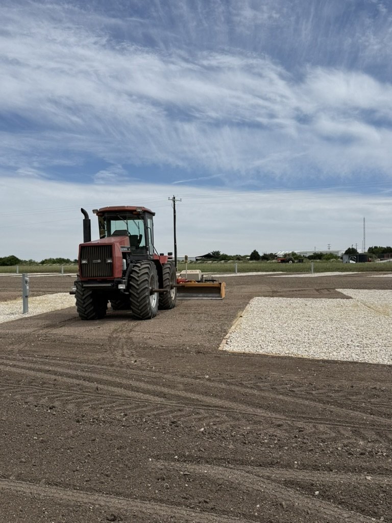 Precision grading with tractor on commercial pad